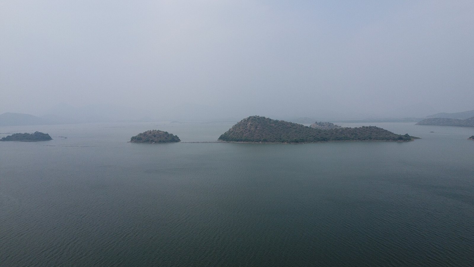 Large water storage tank with surrounding hills